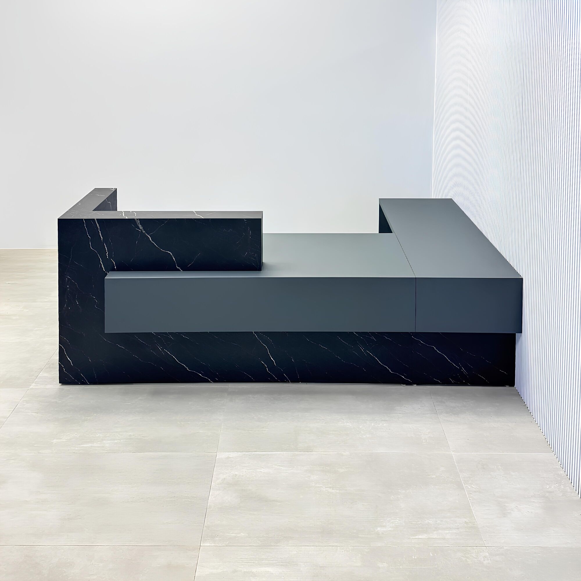108-inch Atlanta L-Shape ADA Reception desk with gray traceless laminate desk, base, and return. Counter top and front accent in black stone palazzo.