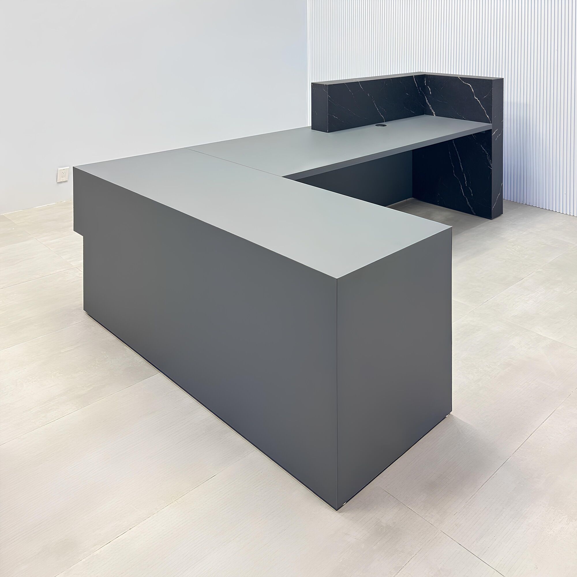 108-inch Atlanta L-Shape ADA Reception desk with gray traceless laminate desk, base, and return. Counter top and front accent in black stone palazzo.