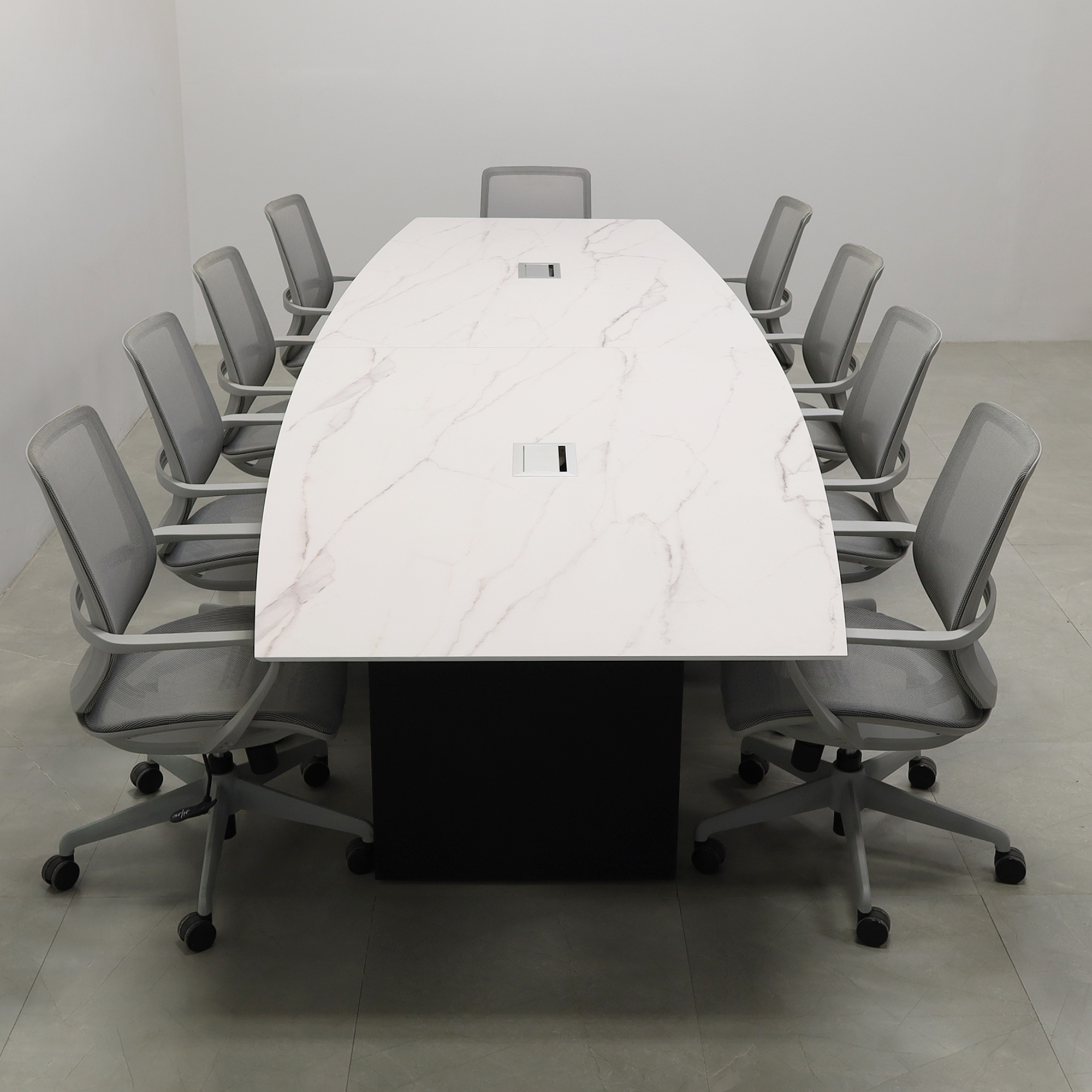 144-inch Aurora Boat Conference Table in 1/2-inch Solenne marble engineered surface top, black traceless laminate standard base, and 2 silver MX3 power boxes.