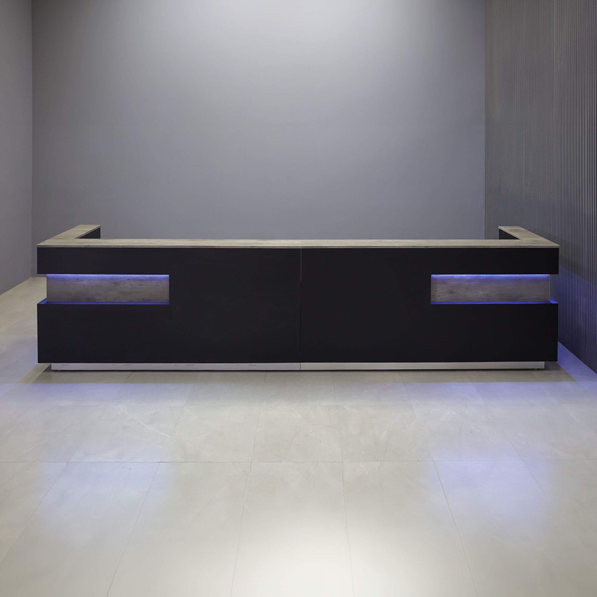 180-inch Manhattan Large U-Shape Custom Reception Desk in metropolitan concrete PVC counter top & accent panel, black traceless laminate main desk, brushed aluminum toe-kick, and color changing LED.