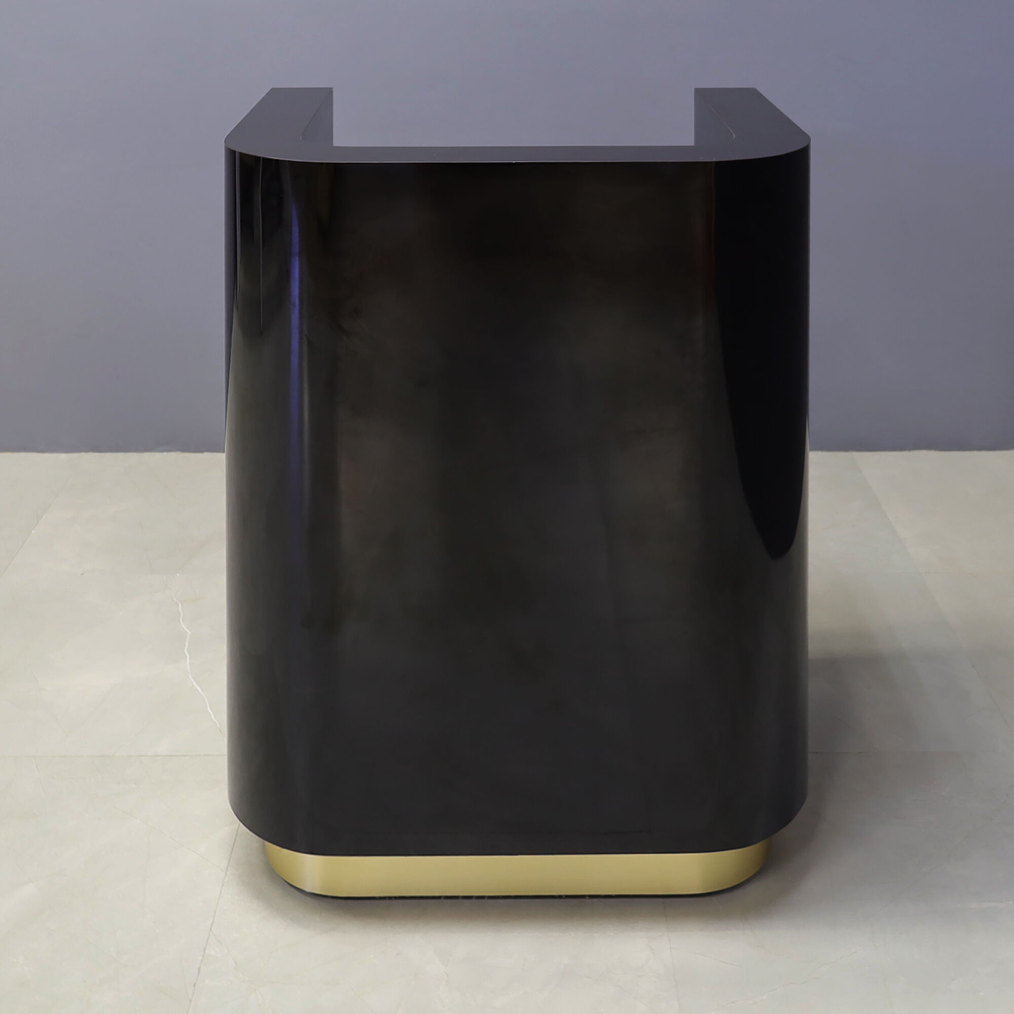 32-inch Nola Podium & Host Custom Desk in black gloss laminate main desk, and brushed gold toe-kick.