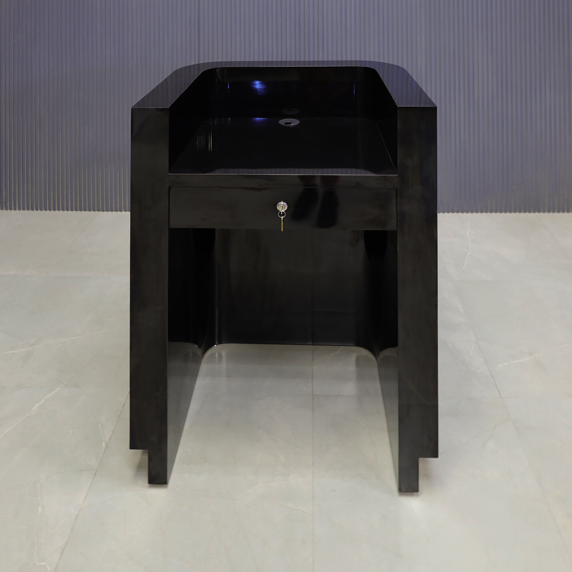 32-inch Nola Podium & Host Custom Desk in black gloss laminate main desk, and brushed gold toe-kick. Built-in pencil drawer with lock.