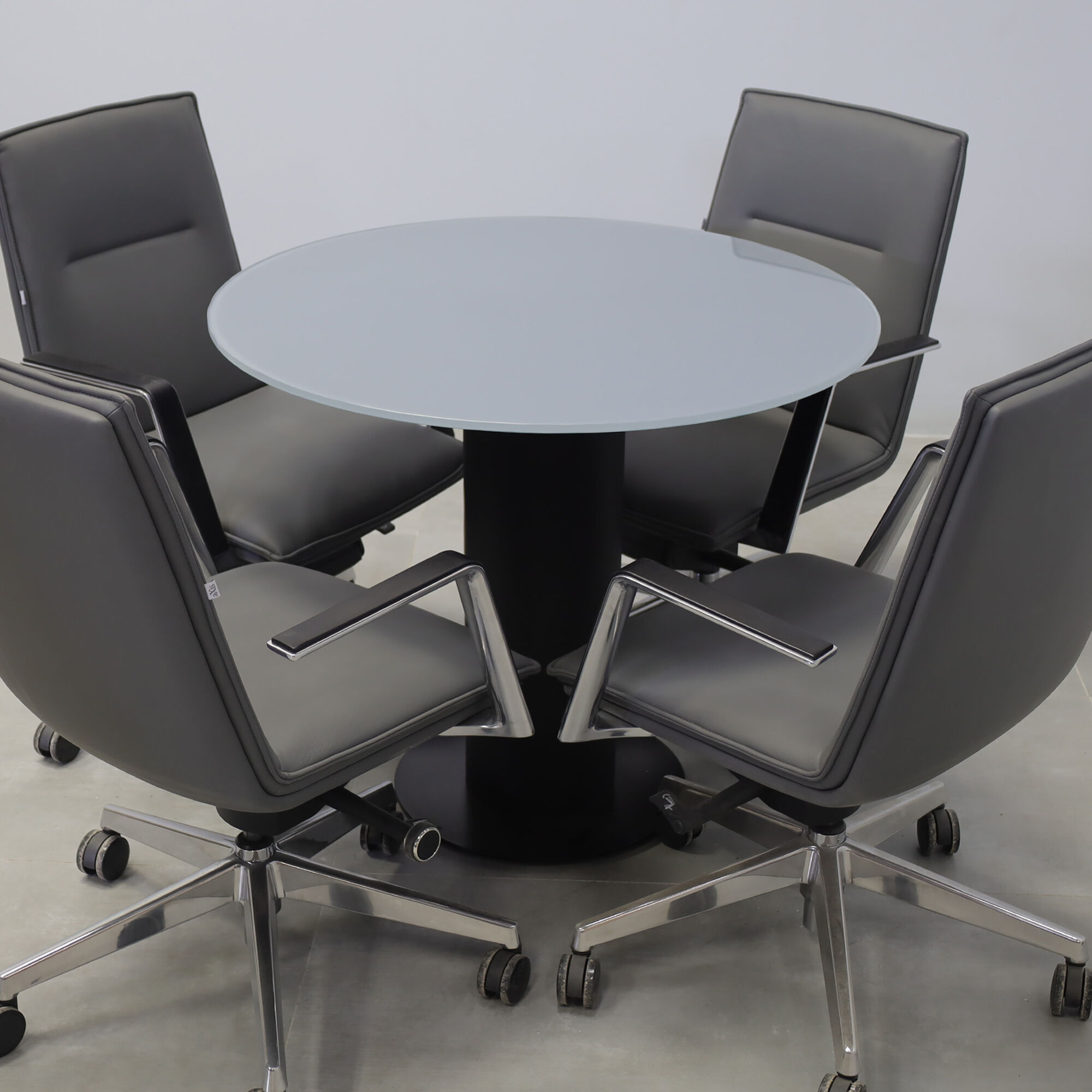36-inch Omaha Round Conference Table with X3 Base in dark gray tempered glass top, black traceless laminate pedestal, and black stainless steel base.