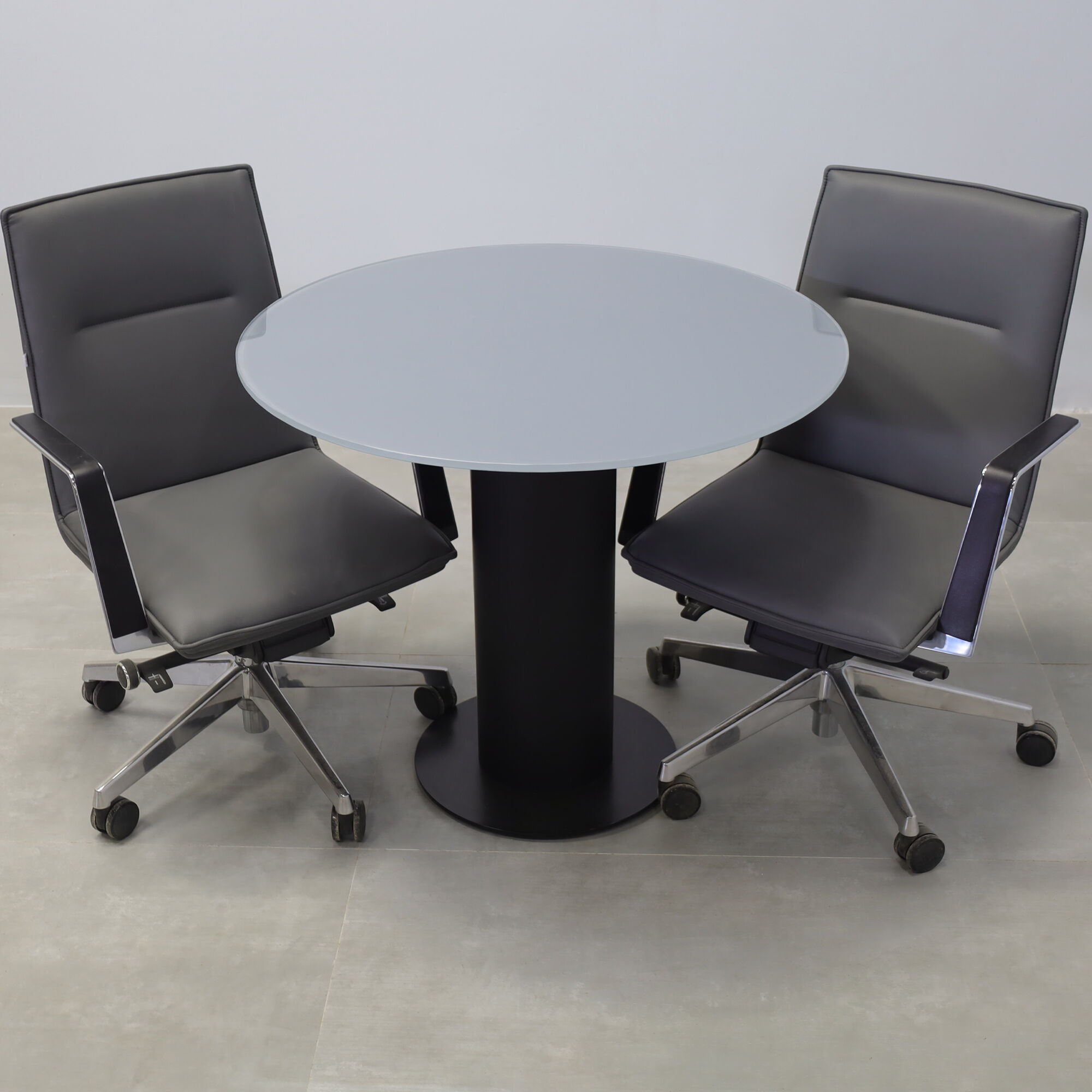 36-inch Omaha Round Conference Table with X3 Base in dark gray tempered glass top, black traceless laminate pedestal, and black stainless steel base.