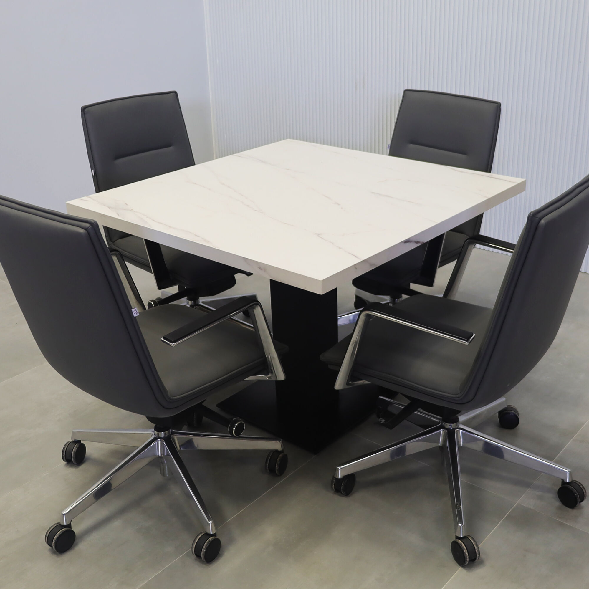 40-inch California X2 Round Conference Table in 1 1/2-inch solenne marble engineered surface top, black traceless laminate pedestal, metal powder coated base in black.