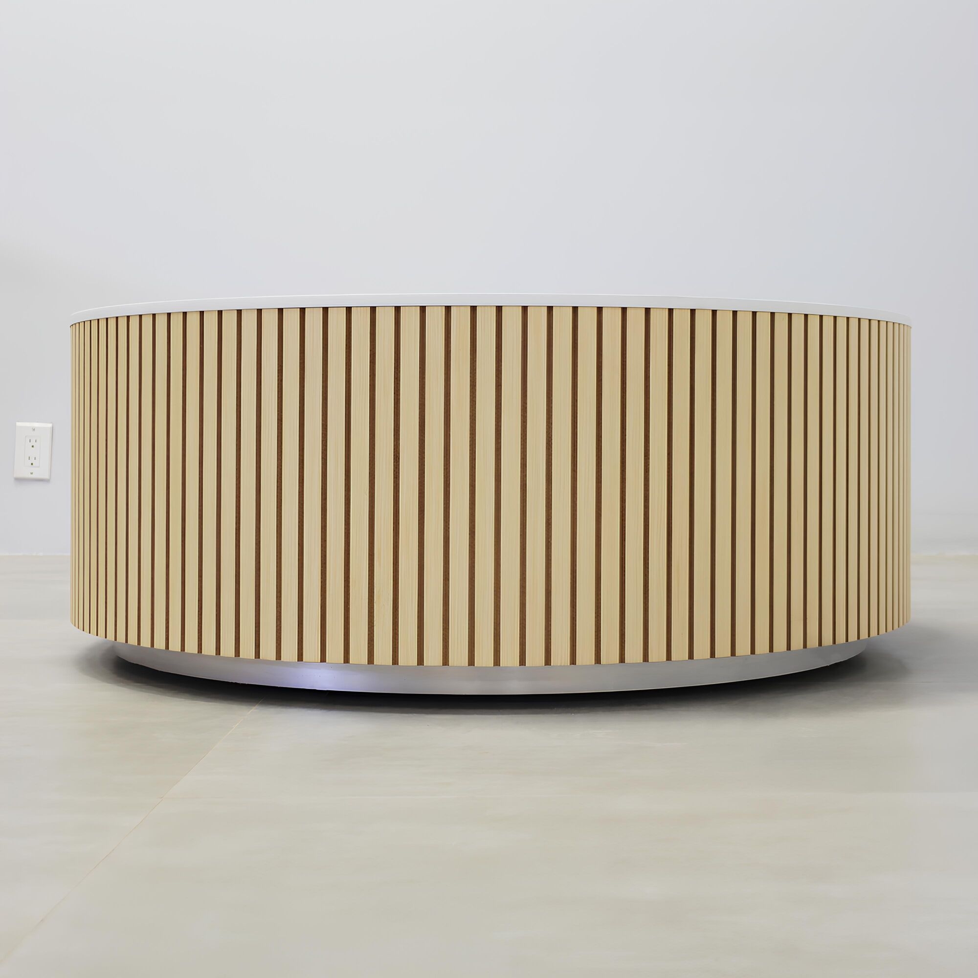 42-inch Norfolk Round Lobby Table with solenne marble engineered surface top, maple tambour table, and brushed aluminum toe-kick.