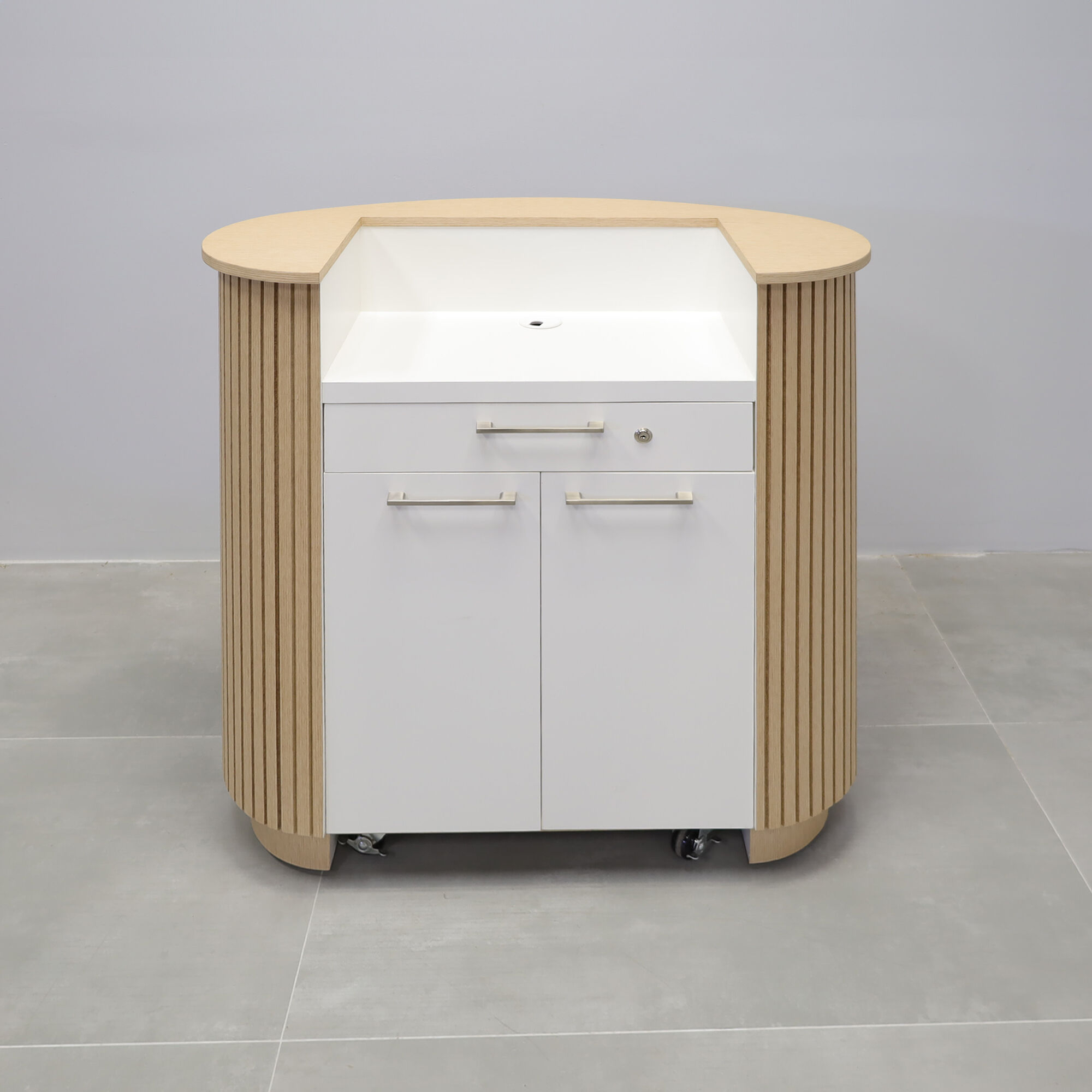 42-inch The Pill Podium & Host Custom Desk in white oak veneer top & toe-kick, white oak tambour main desk, and dover off-white matte laminate workspace. Built-in pencil drawer with lock, two doors with adjustable shelf and set of wheels.