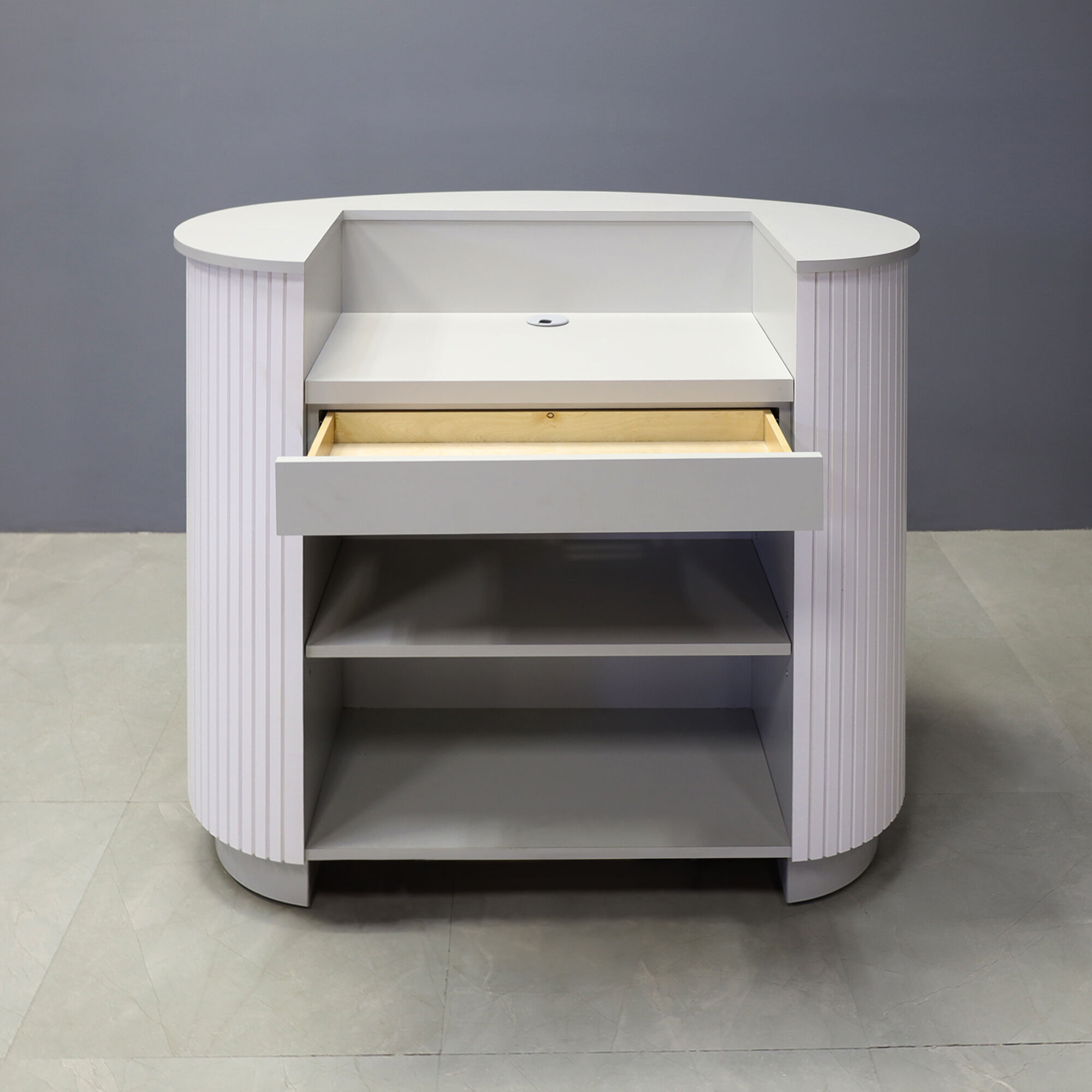 48-inch The Pill Podium & Host Custom Desk in folkstone gray matte laminate top counter, workspace & toe-kick, and white matte tambour main desk. Small drawer and adjustable shelf.