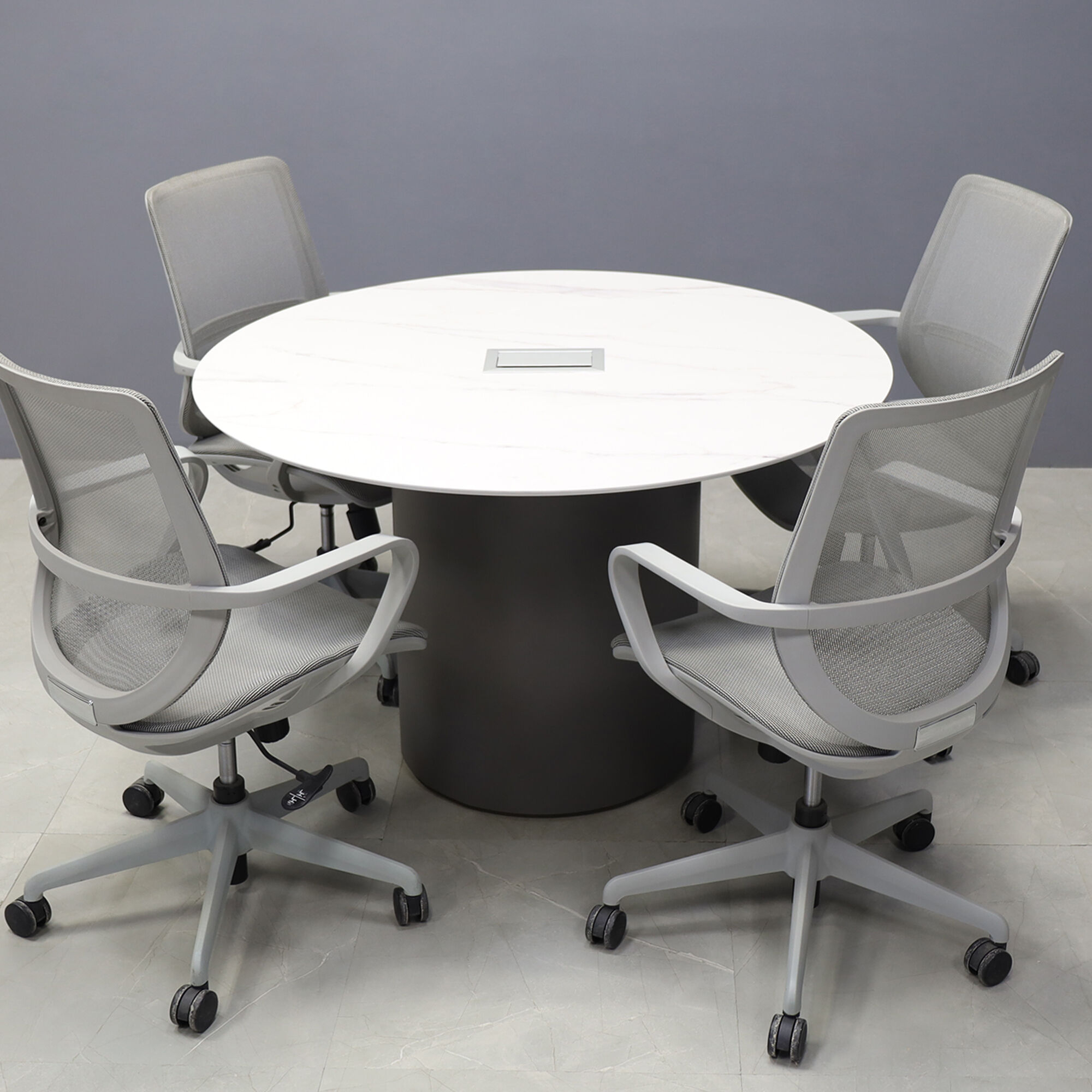 48-inch Aurora Round Conference Table in 1/2-inch solenne marble engineered surface top, dark gray traceless laminate base, and silver MX3 power box.