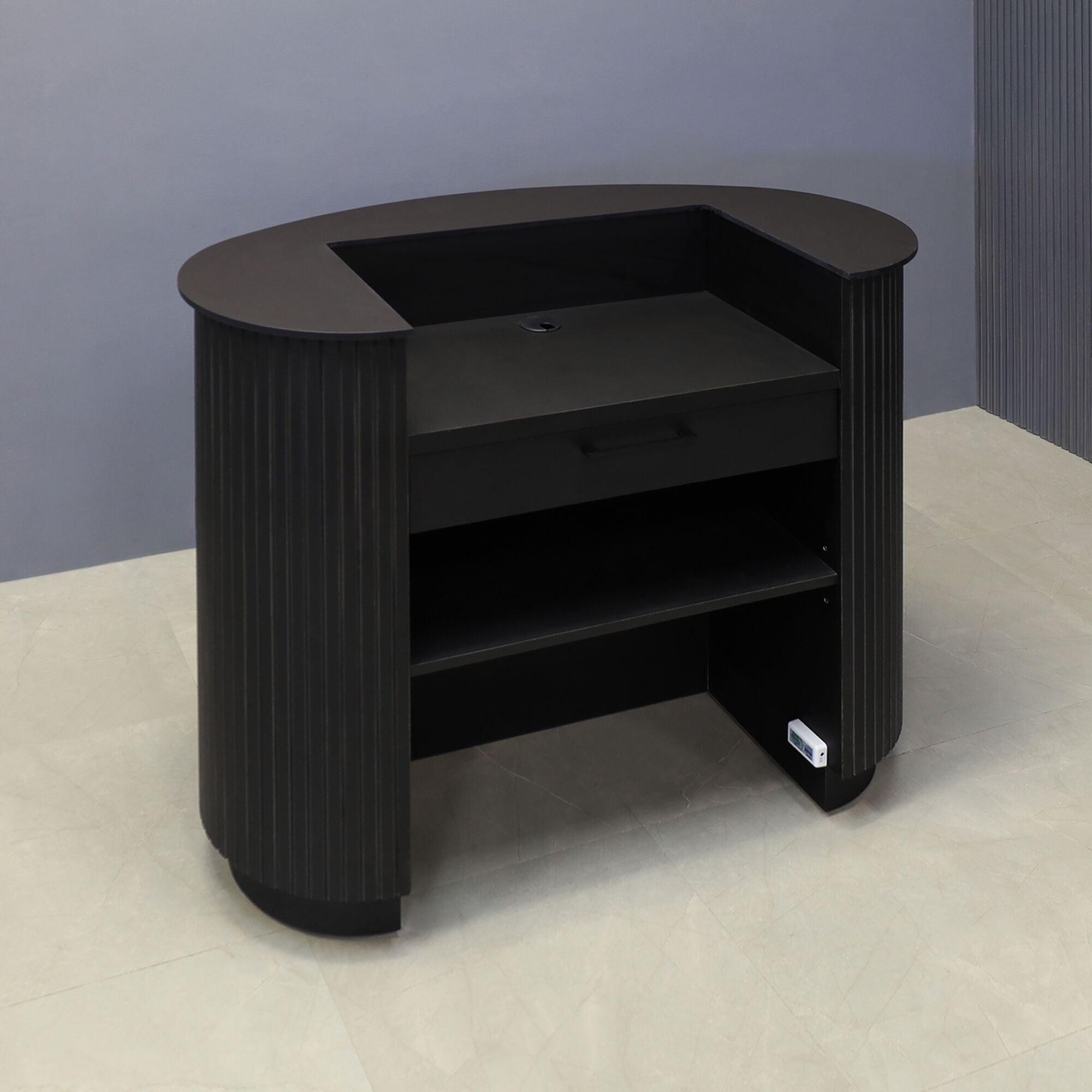 48-inch The Pill Podium & Host Custom Desk in 1/2-inch black traceless engineered surface top counter, black traceless tambour main desk, black traceless laminate workspace & toe-kick, and color changing LED. Small drawer and adjustable shelf.