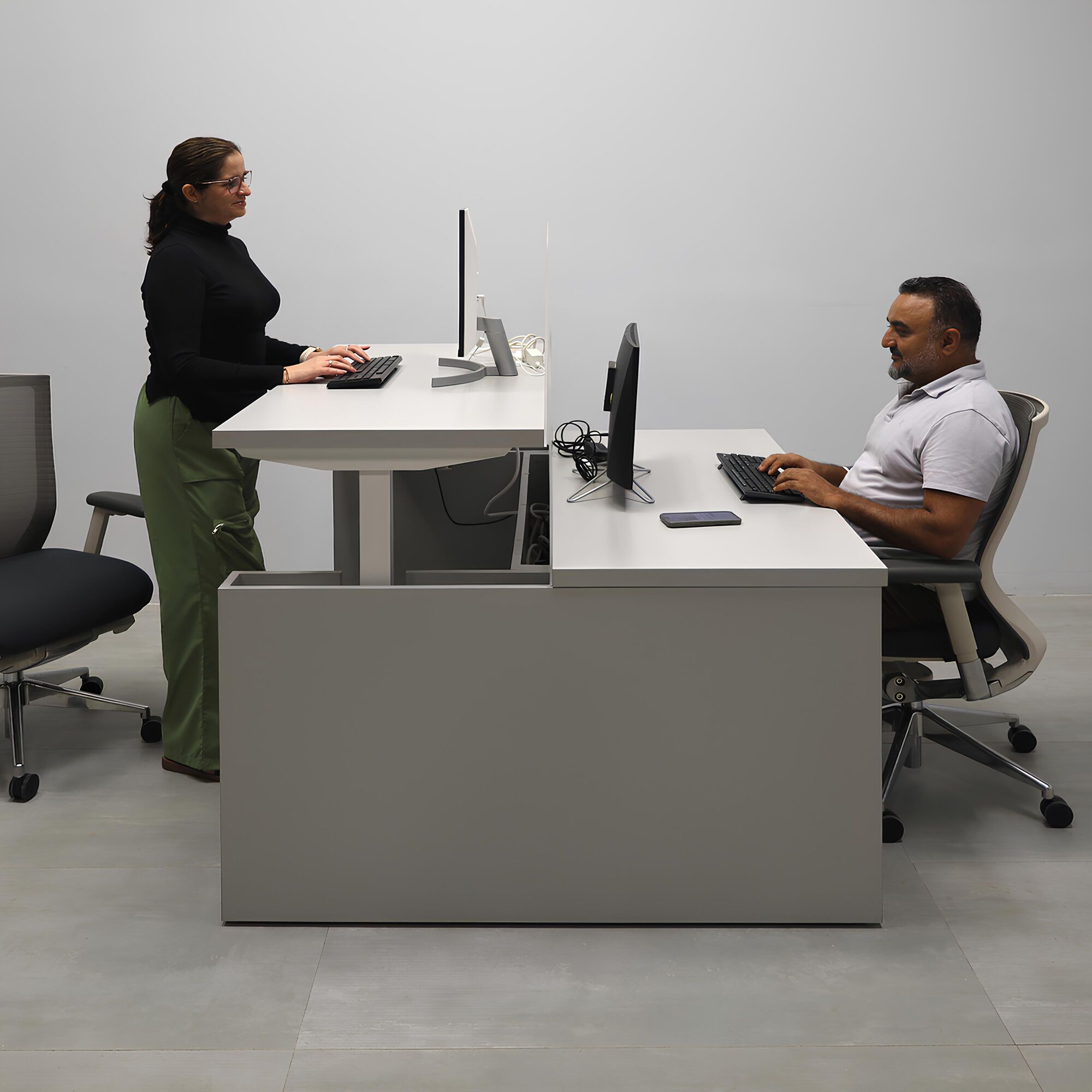 57 1/2- Inch Nashville Sit-Stand Custom Workstation with Folkstone Matte laminate top, Folkstone Matte laminate base, and Frosted Acrylic partition.