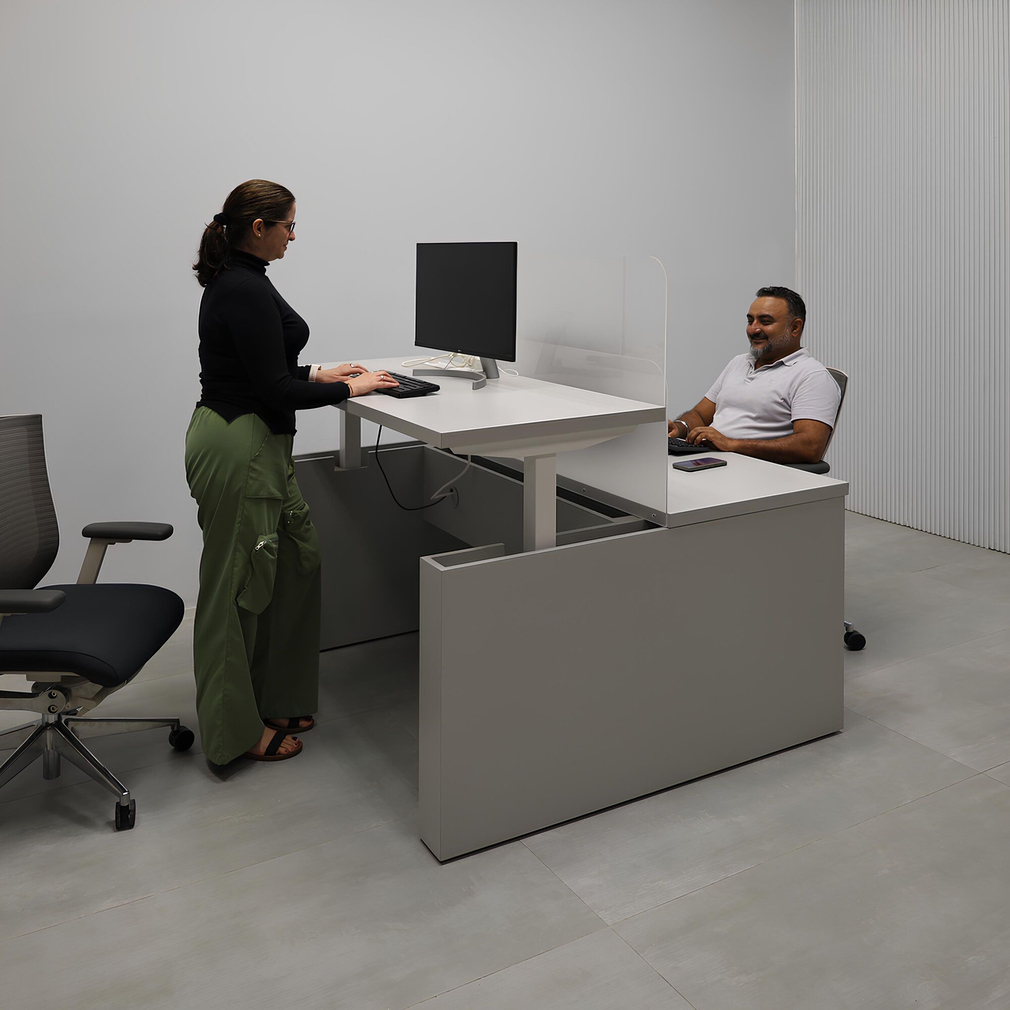 57 1/2- Inch Nashville Sit-Stand Custom Workstation with Folkstone Matte laminate top, Folkstone Matte laminate base, and Frosted Acrylic partition.