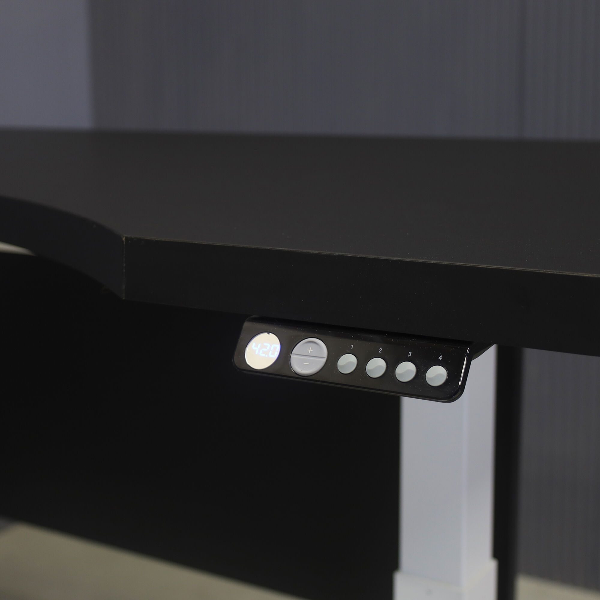 60-inch aXis Sit-stand Executive Desk with black traceless laminate top & privacy panel, and white metal legs, shown here.