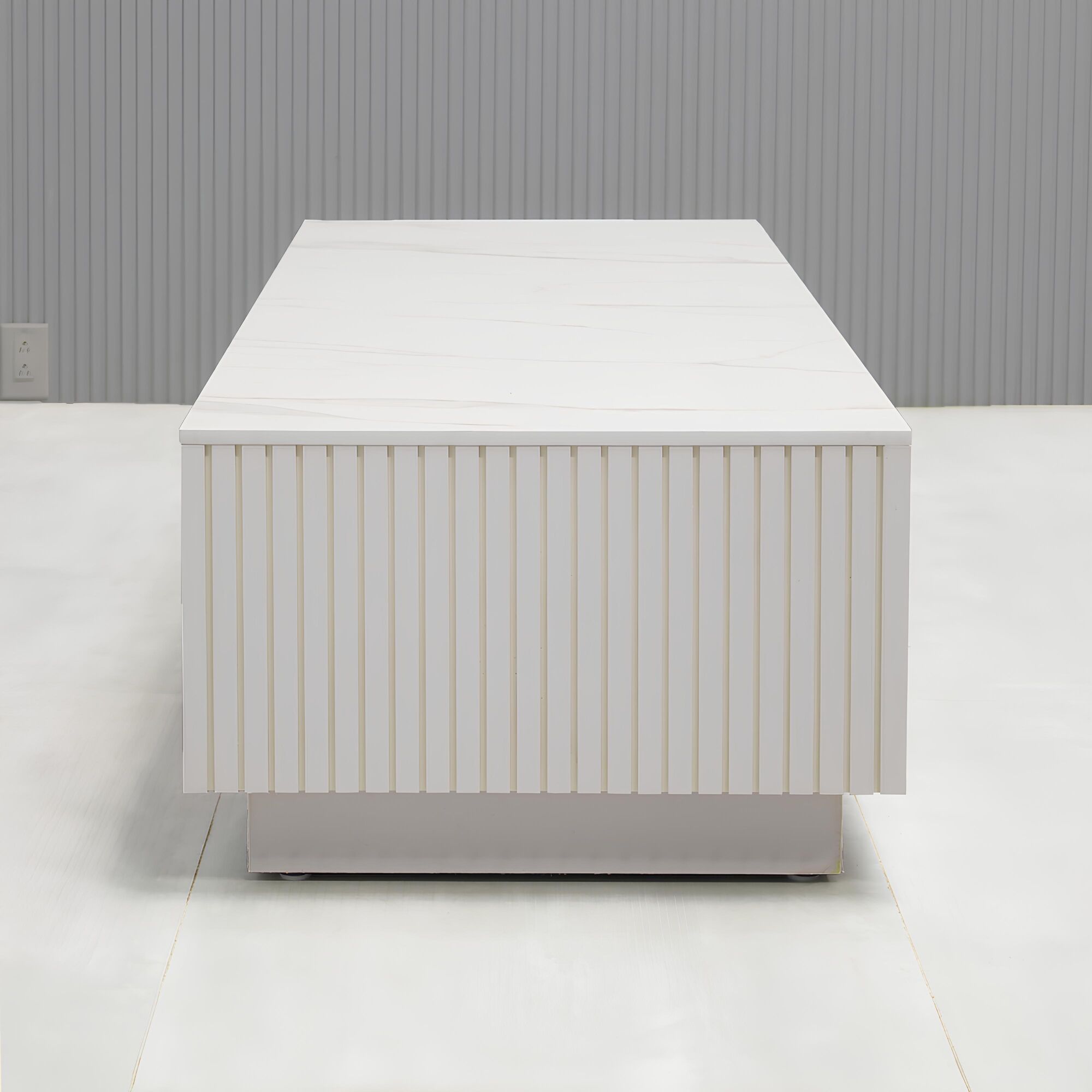 Norfolk Rectangular Lobby Table in solenne engineered surface top, white gloss tambour side table, and white gloss laminate toe-kick.