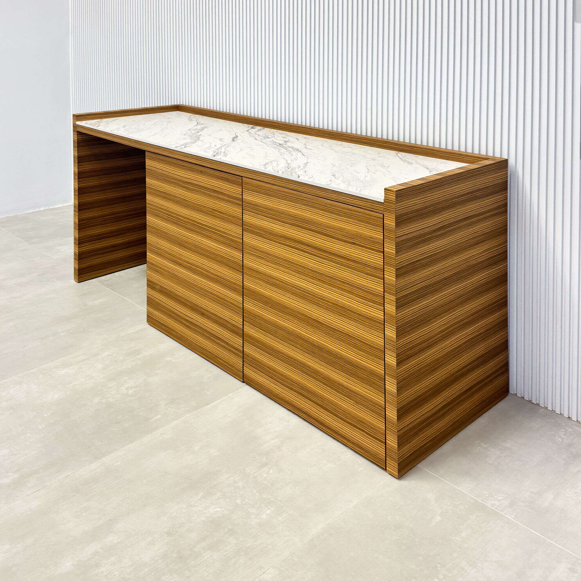 72-inch Avenue Beverage Station with calcutta blanc engineered surface top, zebrawood veneer main body, and push-to-open door mechanism.