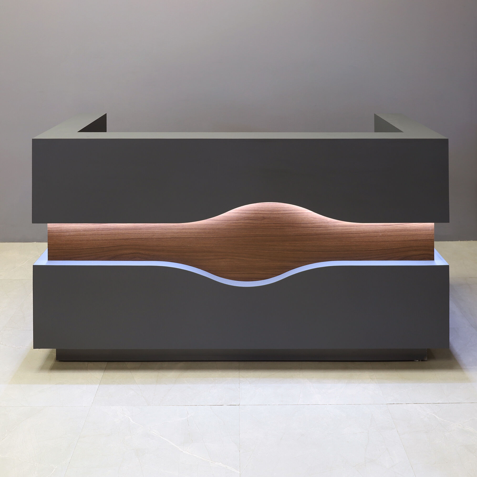 72-inch Wave Reception Desk in dark gray traceless laminate counter, desk & toe-kick, with walnut heights matte laminate wave accent front, and war, white LED, shown here.