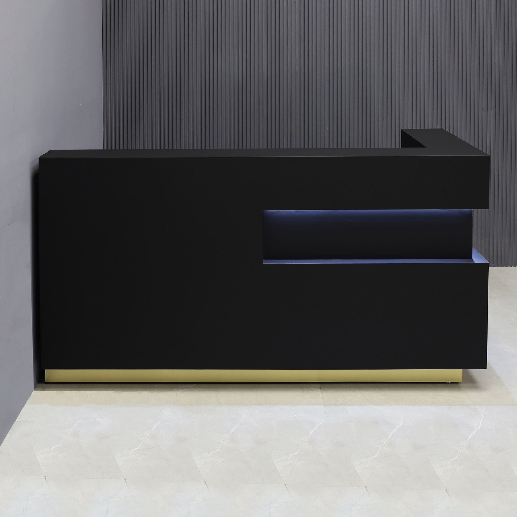 72-inch Manhattan L-Shape Custom Reception Desk in BLACK TRACELESS laminate accent panel & main desk, and gold aluminum toe-kick, with warm white LED, shown here.