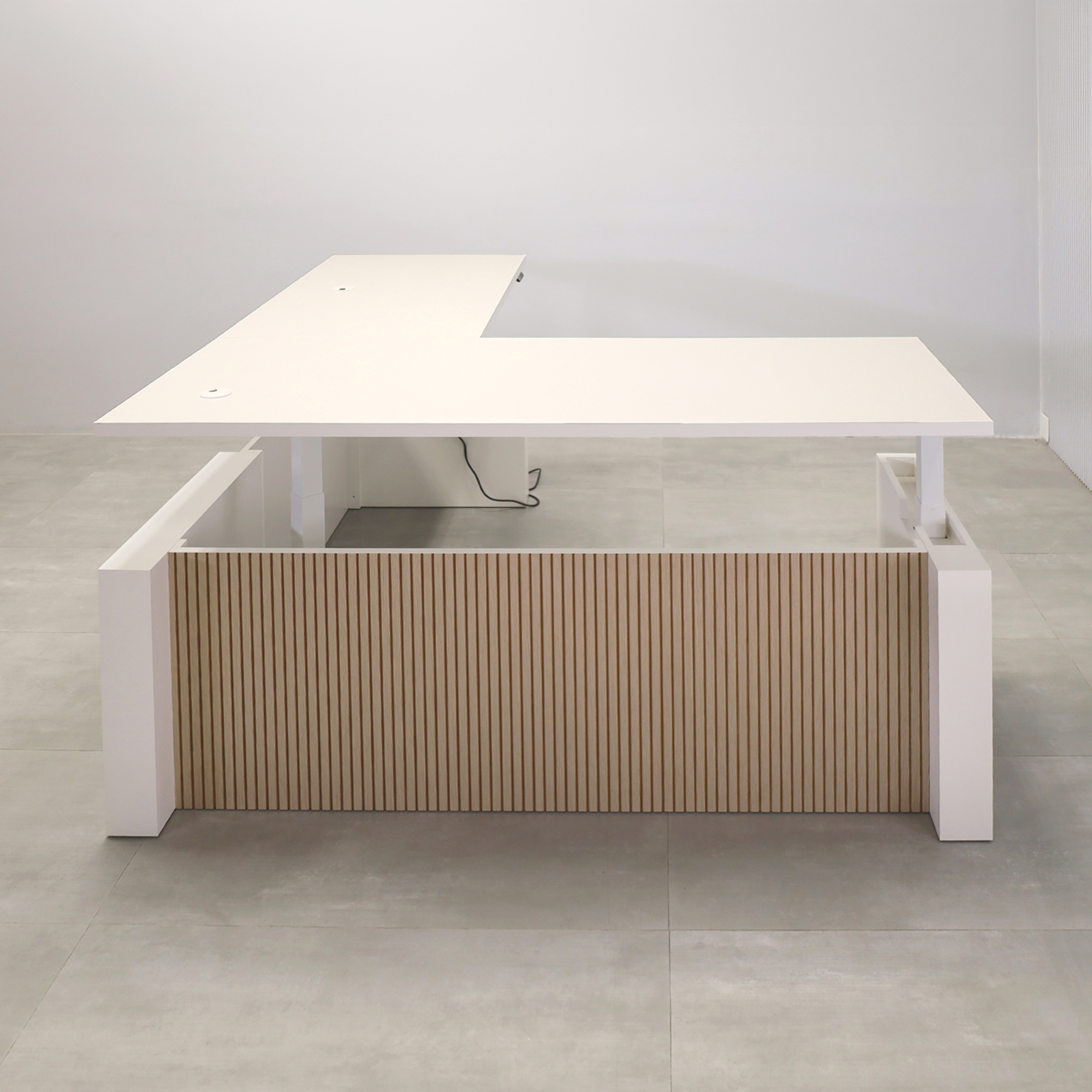 80-inch Denver L-Shape Laminate Executive Desk with Sit-Stand Mechanism with Dover Off-White matte laminate top and base. Washed Oak tambour privacy panel and white base.