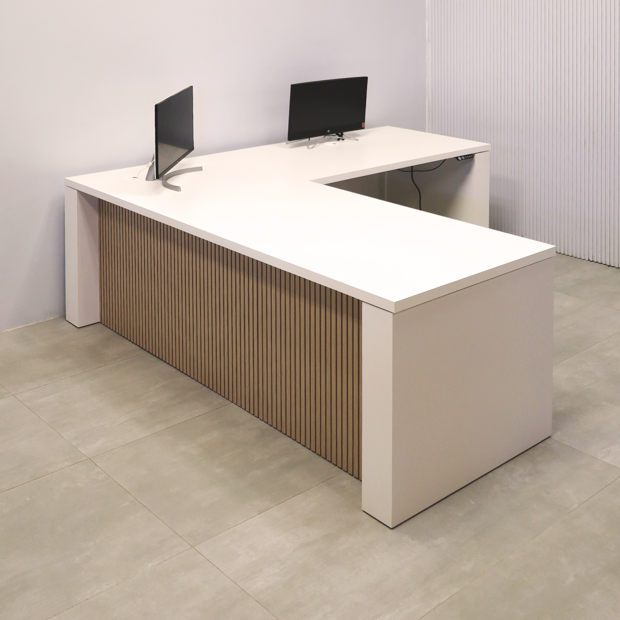 80-inch Denver L-Shape Laminate Executive Desk with Sit-Stand Mechanism with Dover Off-White matte laminate top and base. Washed Oak tambour privacy panel and white base.
