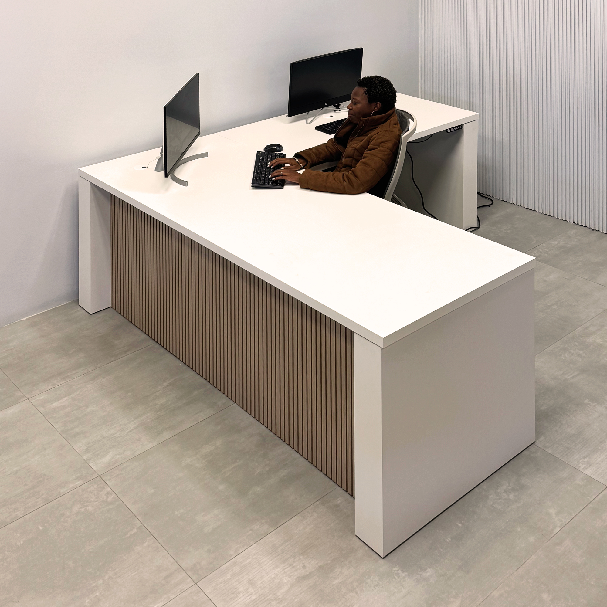 80-inch Denver L-Shape Laminate Executive Desk with Sit-Stand Mechanism with Dover Off-White matte laminate top and base. Washed Oak tambour privacy panel and white base.