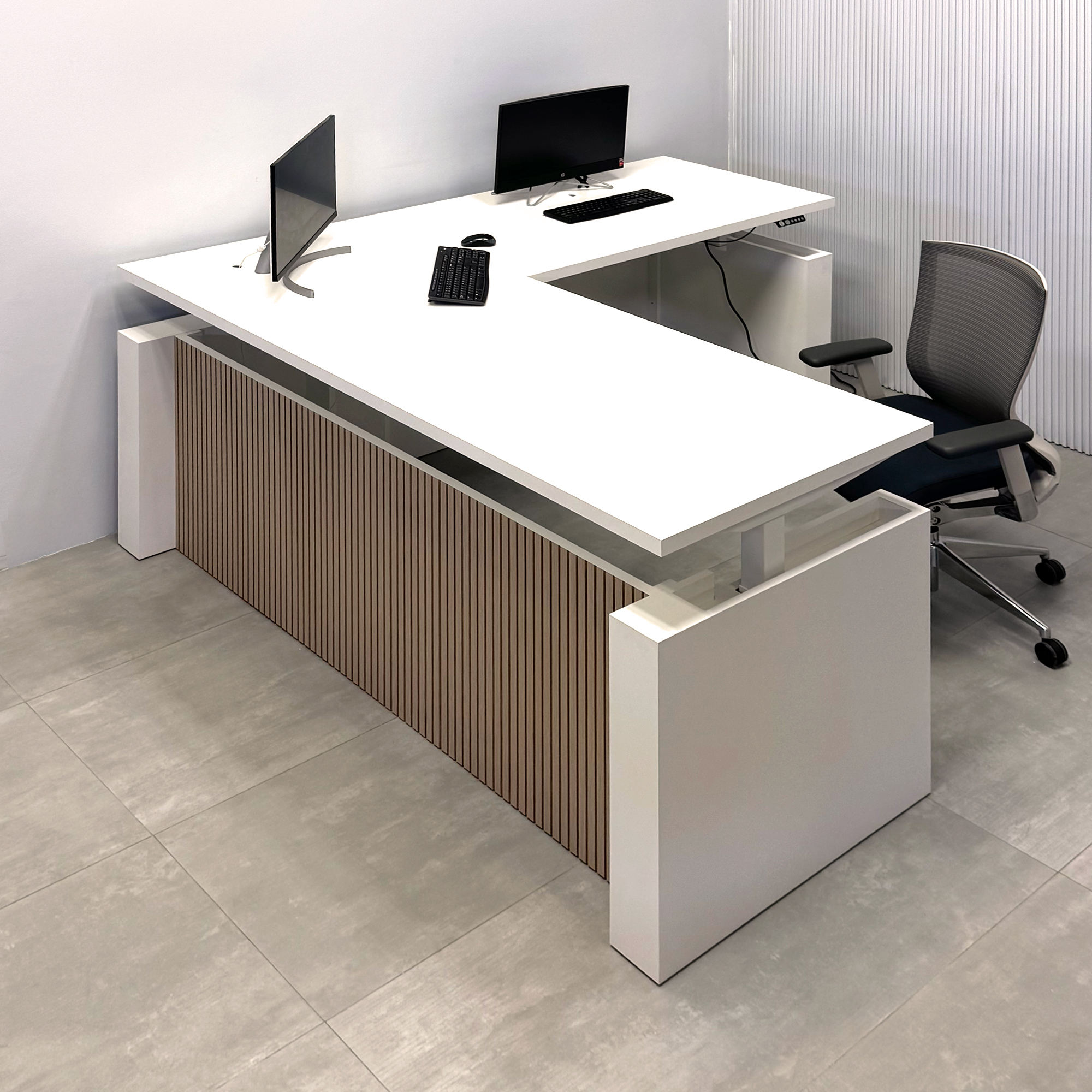 80-inch Denver L-Shape Laminate Executive Desk with Sit-Stand Mechanism with Dover Off-White matte laminate top and base. Washed Oak tambour privacy panel and white base.