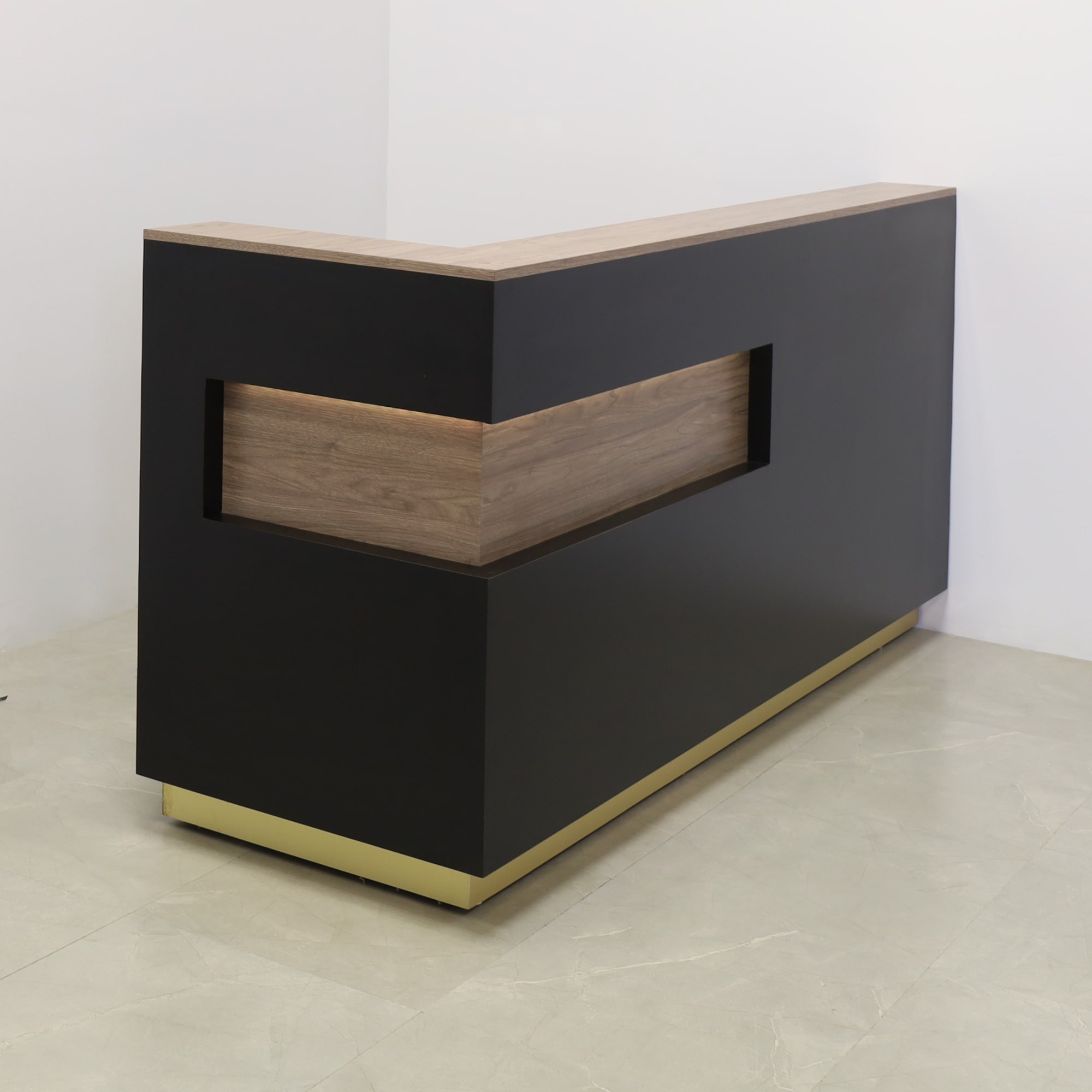 84-inch Manhattan L-Shape Custom Reception Desk in walnut heights matte laminate accent panel and top counter, and BLACK TRACELESS laminate main desk. Gold aluminum toe-kick, with multi-colored LED, shown here.