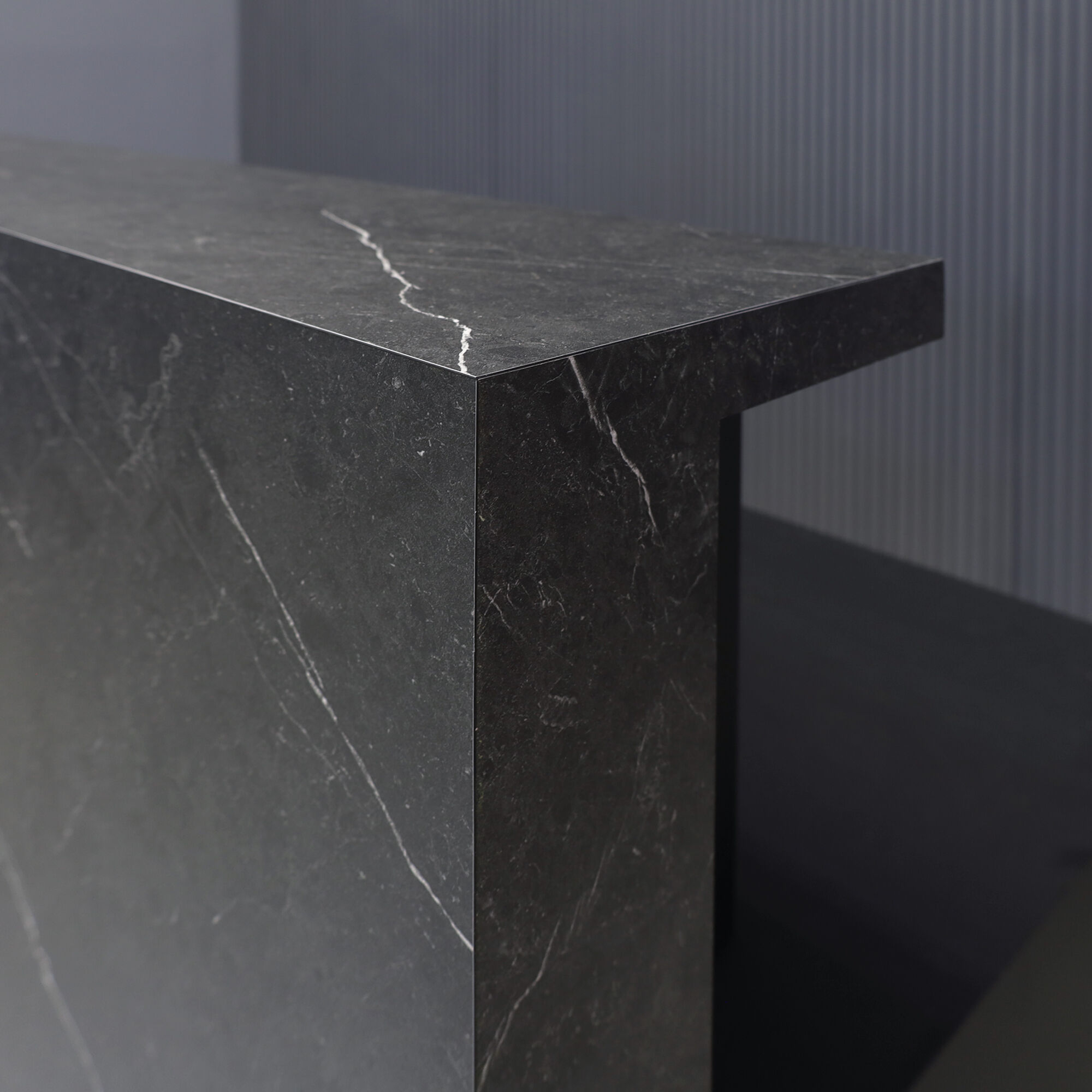 90-inch Los Angeles Custom Reception Desk with the counter on the right side when facing front in black stone PVC, and black traceless laminate desk, with white LED, shown here.