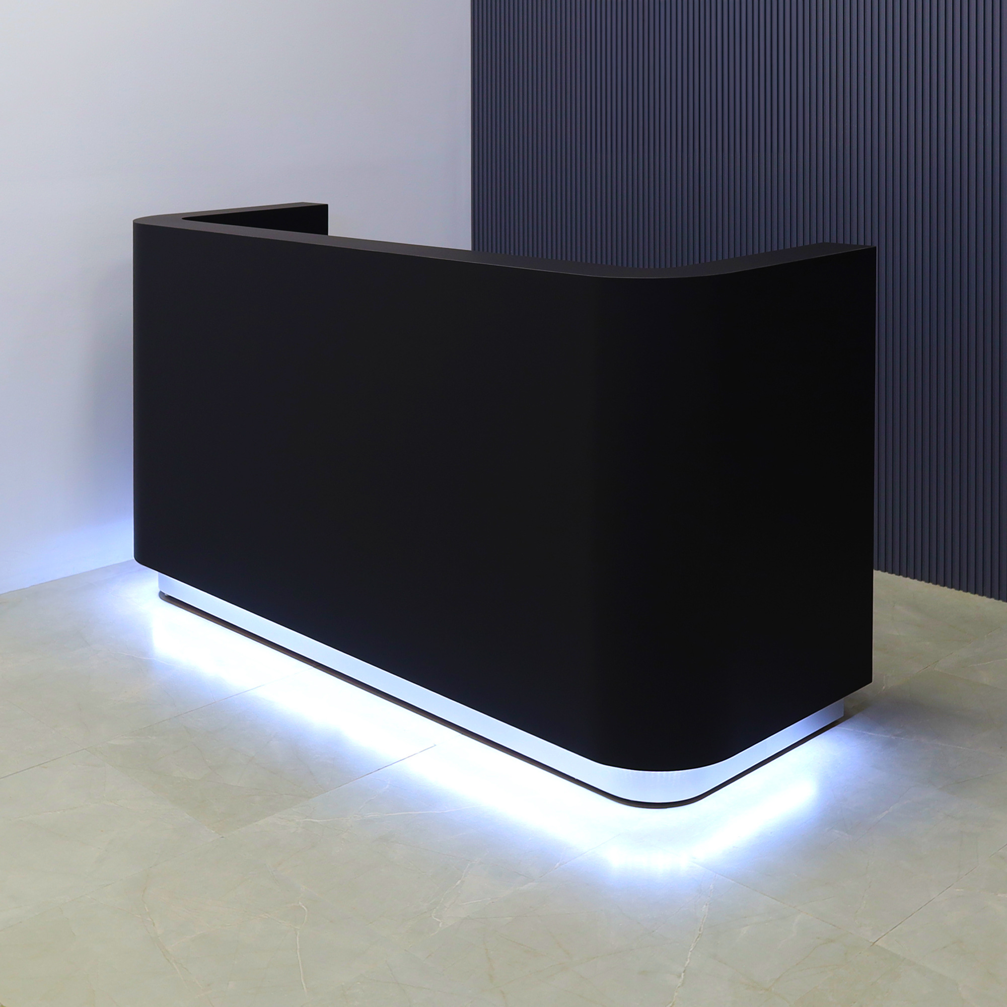 90-inch Nola Custom Reception Desk in black traceless laminate main desk, brushed aluminum toe-kick, and warm white LED.