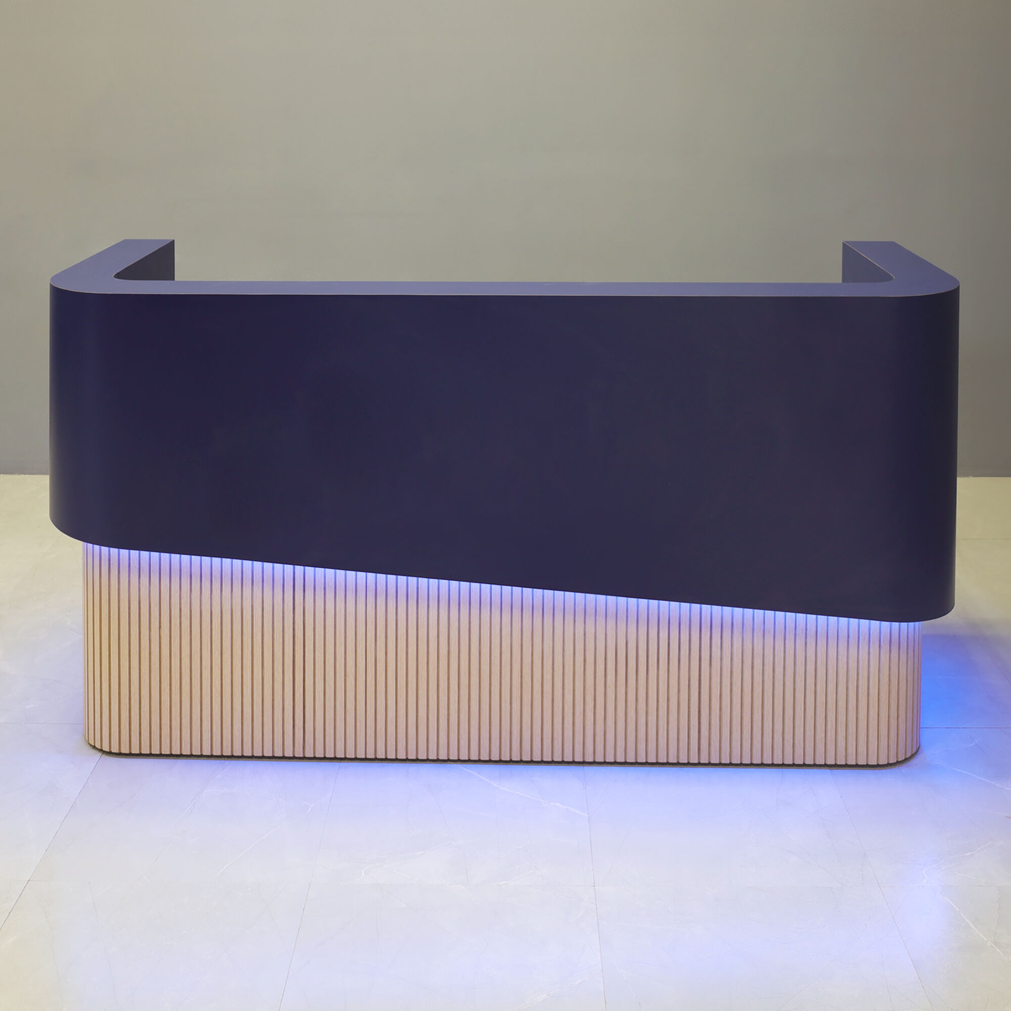 90-inch Nola Curved Custom Reception Desk in navy blue matte laminate counter & inside desk, white oak tambour front desk, and color changing LED.