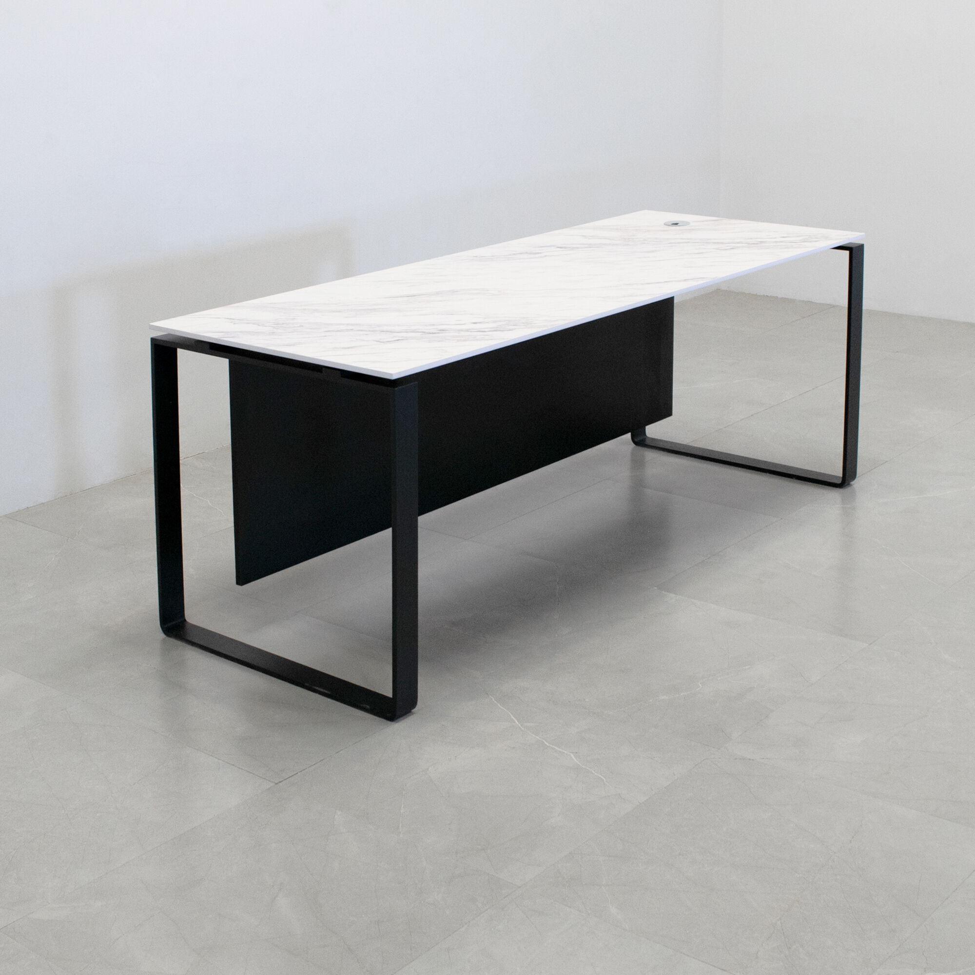 Aspen Straight Executive Desk With 1/2" calcutta blanc engineered surface top, black traceless laminate privacy panel, and black metal legs, shown here.