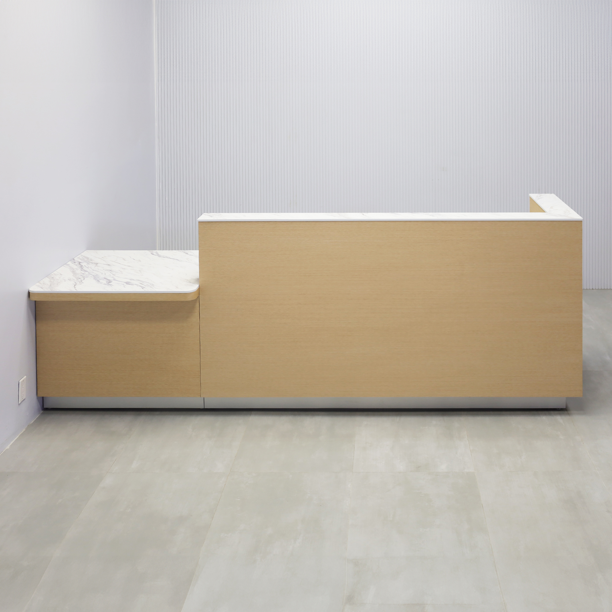 Dallas ADA Compliant Counter Custom Reception Desk with Calcutta Blanc Engineered Surface workspace, White Oak Veneer body finish, and Brushed Aluminum toe-kick. 