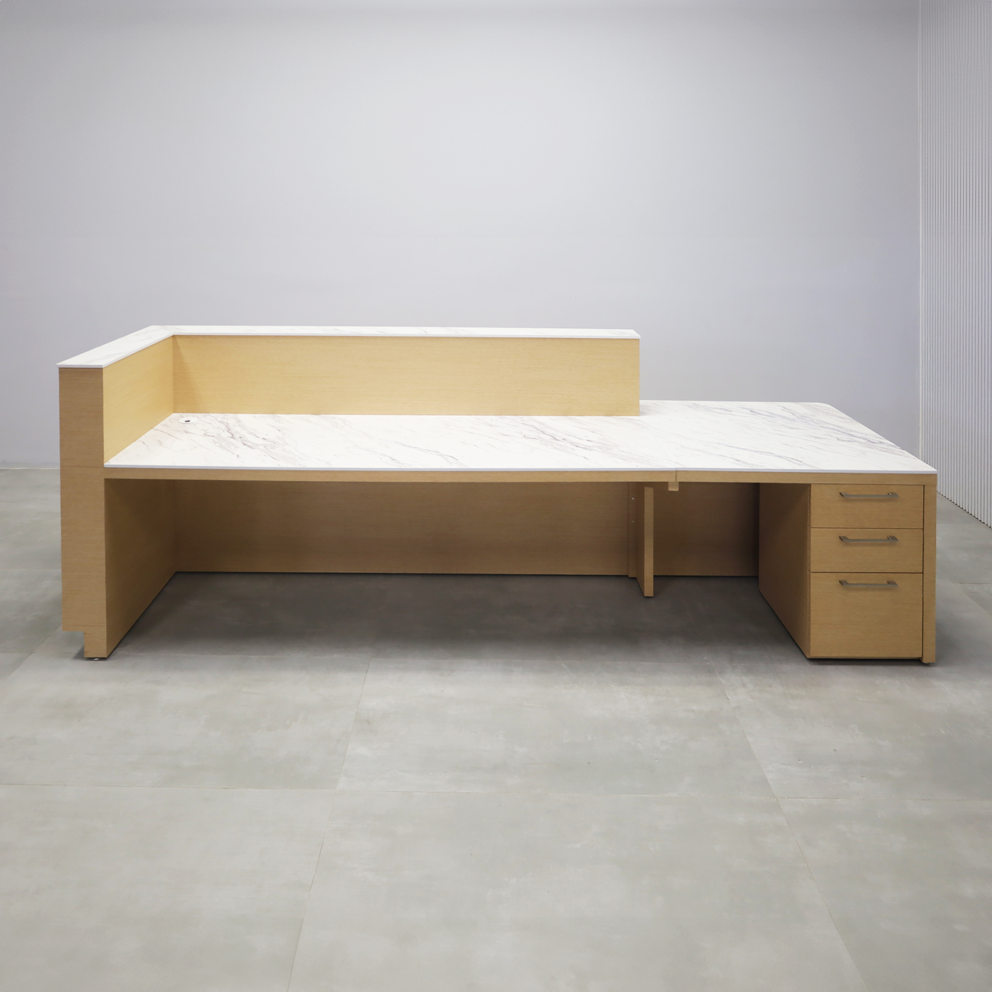 Dallas ADA Compliant Counter Custom Reception Desk with Calcutta Blanc Engineered Surface workspace, White Oak Veneer body finish, and Brushed Aluminum toe-kick.