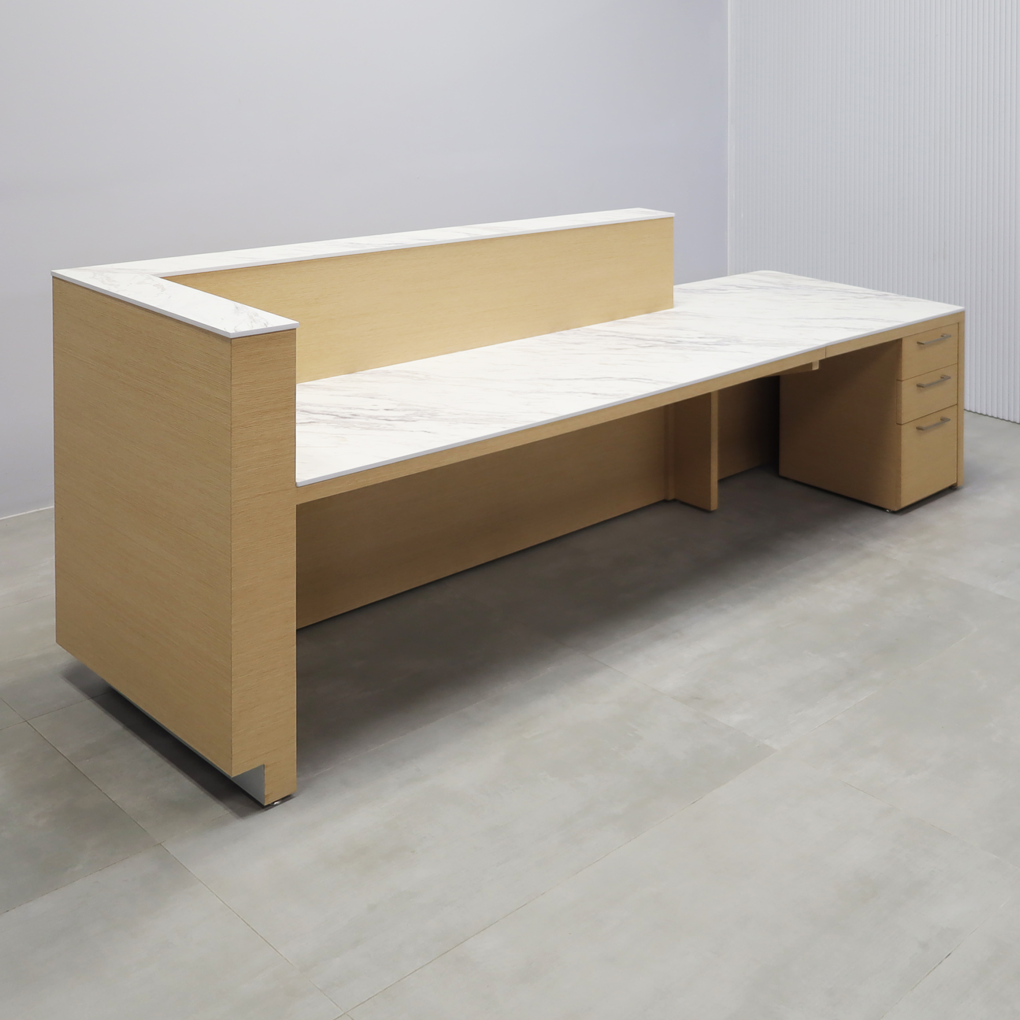 Dallas ADA Compliant Counter Custom Reception Desk with Calcutta Blanc Engineered Surface workspace, White Oak Veneer body finish, and Brushed Aluminum toe-kick.