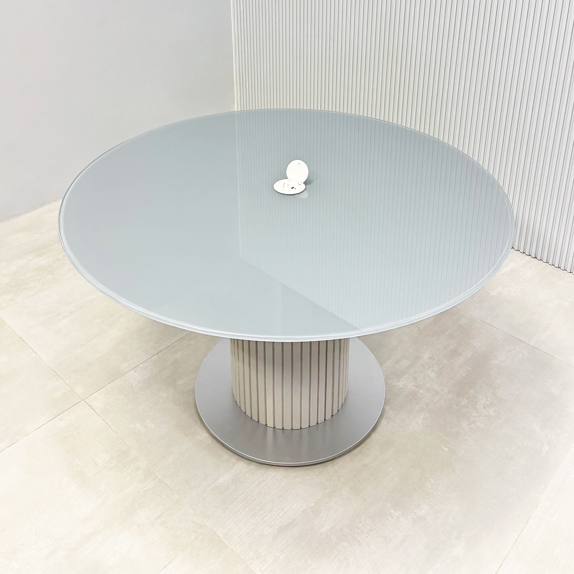 Omaha Round Conference Table with tempered glass top, fog gray tambour pedestal, and silver base.
